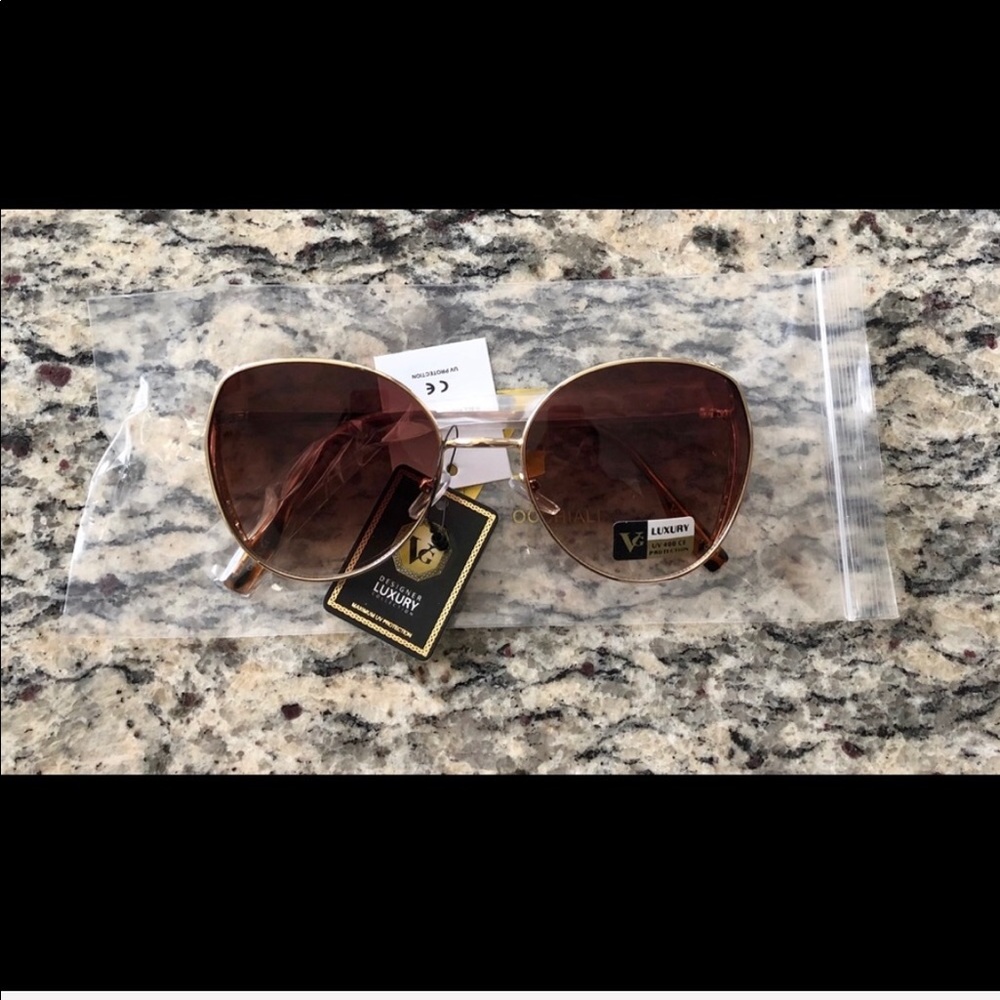 Brown luxury sunglasses with UV protection. NWOT.